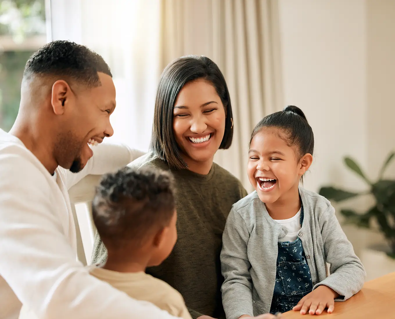 Happy Belleville, IL family smiling together indoors, representing reliable home comfort from local heating and cooling services.