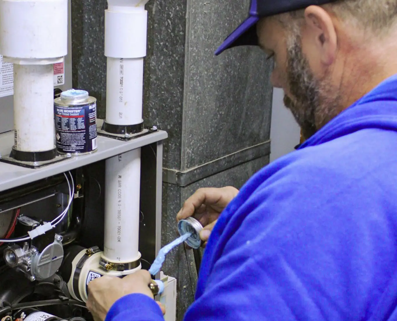 Craig-Air Cooling & Heating HVAC technician performing maintenance on HVAC system in O'Fallon IL