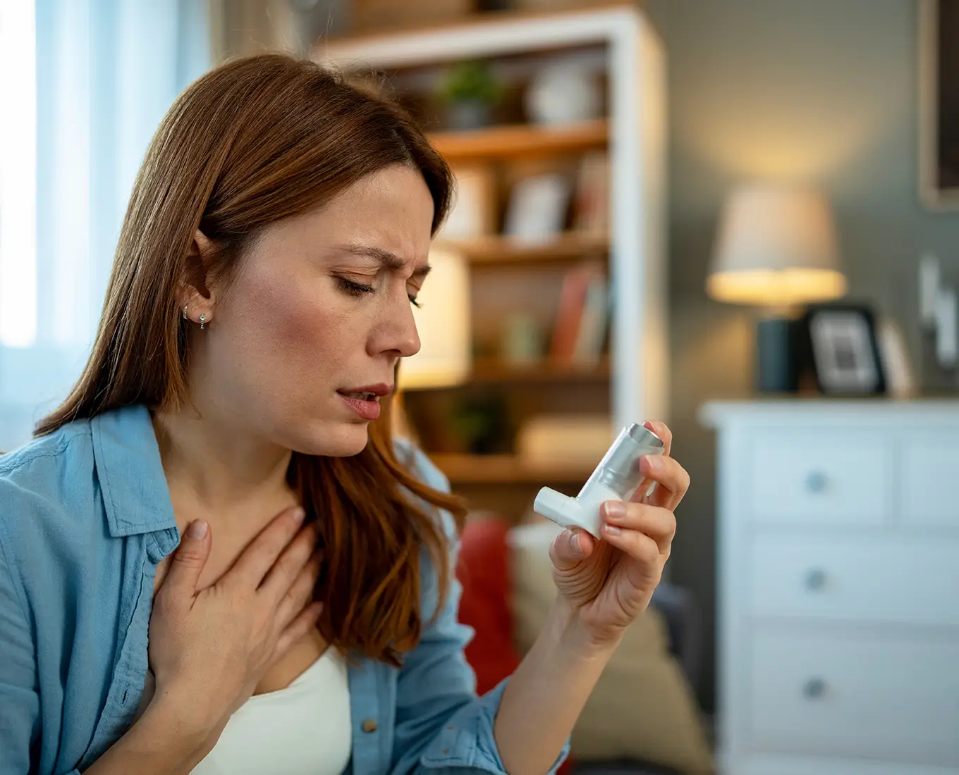 woman suffering from asthma due to poor indoor air quality.