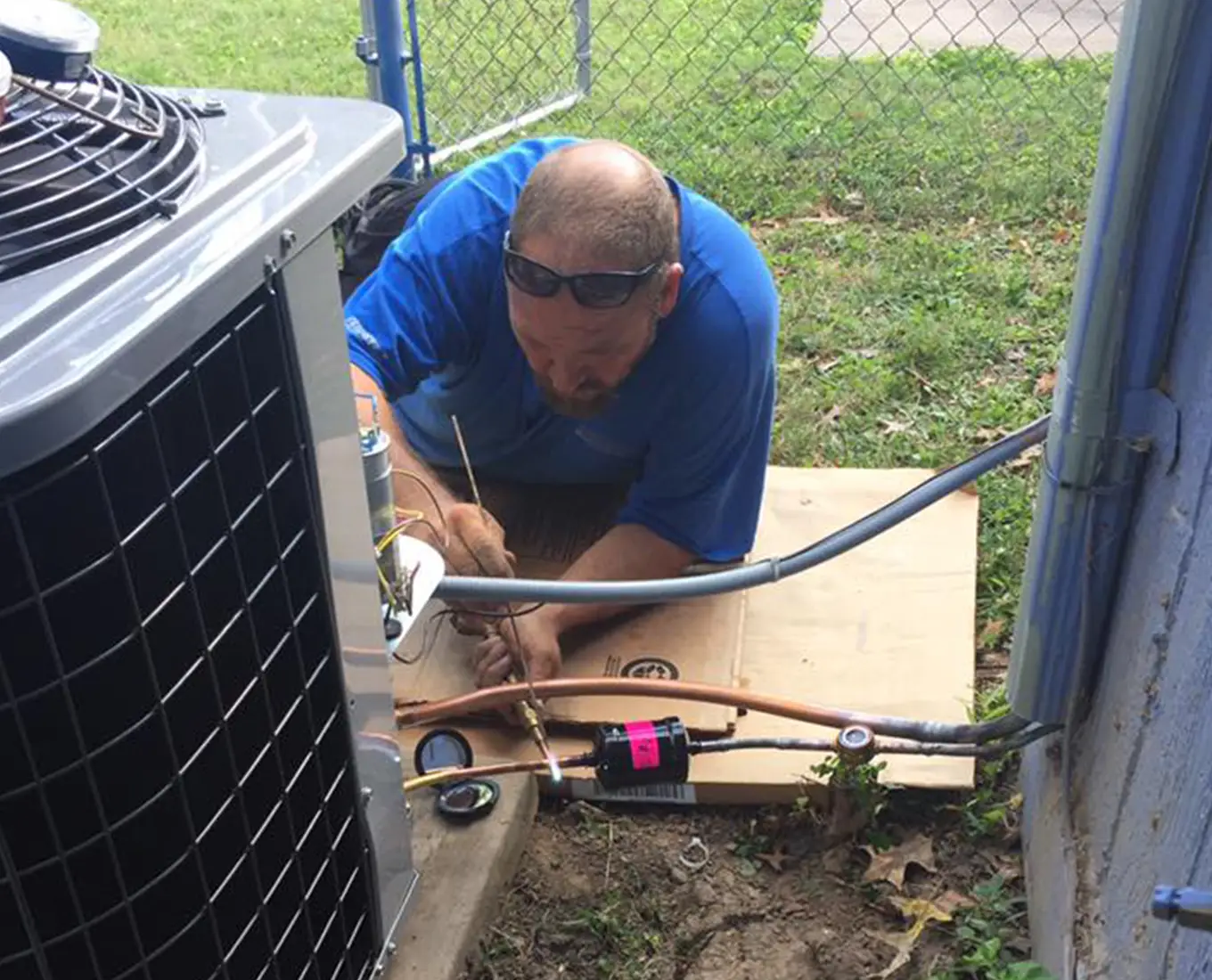 AC repair technician working on air conditioner in O’Fallon IL