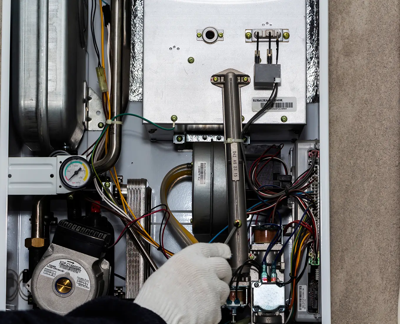 close-up of an HVAC technician performing repair work on a home furnace in O'Fallon IL