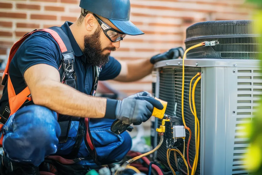HVAC technician repairing air conditioner in o'fallon il
