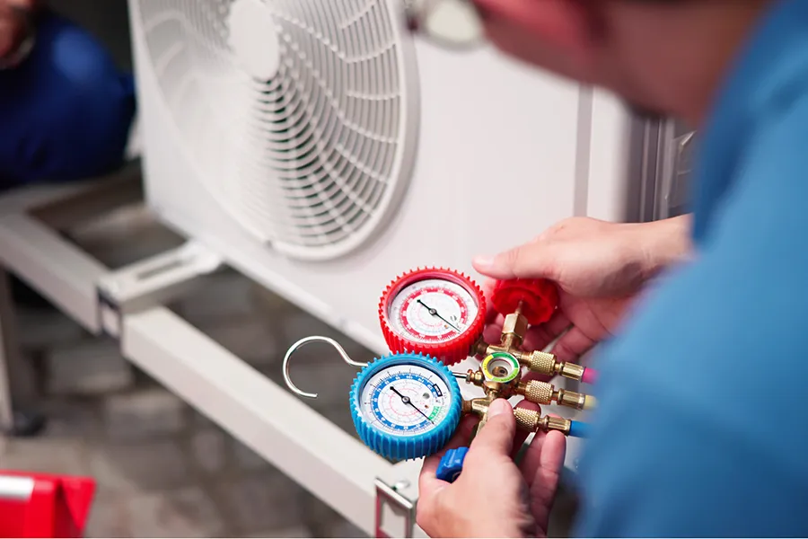 Commercial HVAC Worker Inspecting Air Conditioning System in o'fallon il